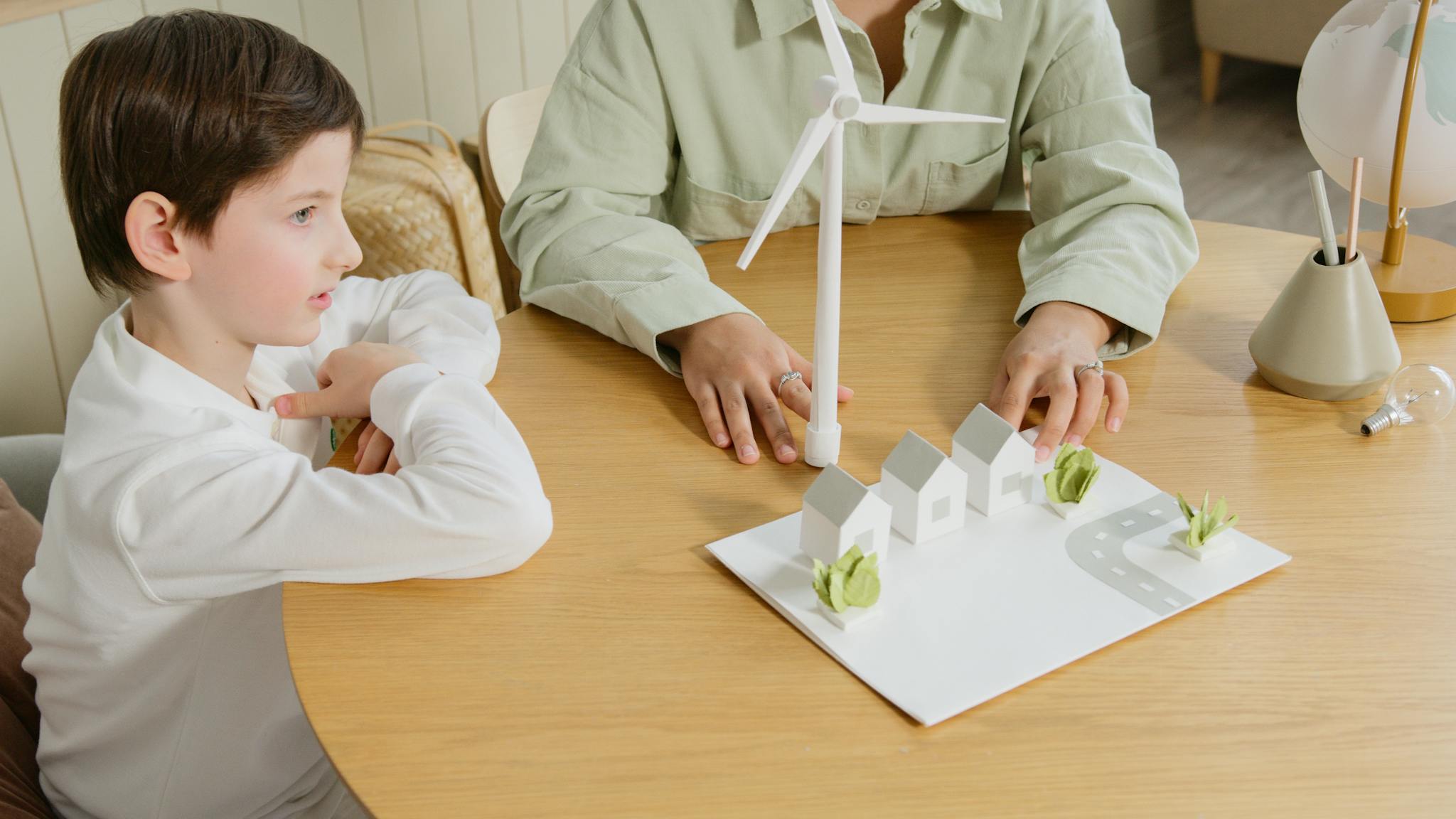 A child explores renewable energy models in a classroom setting.